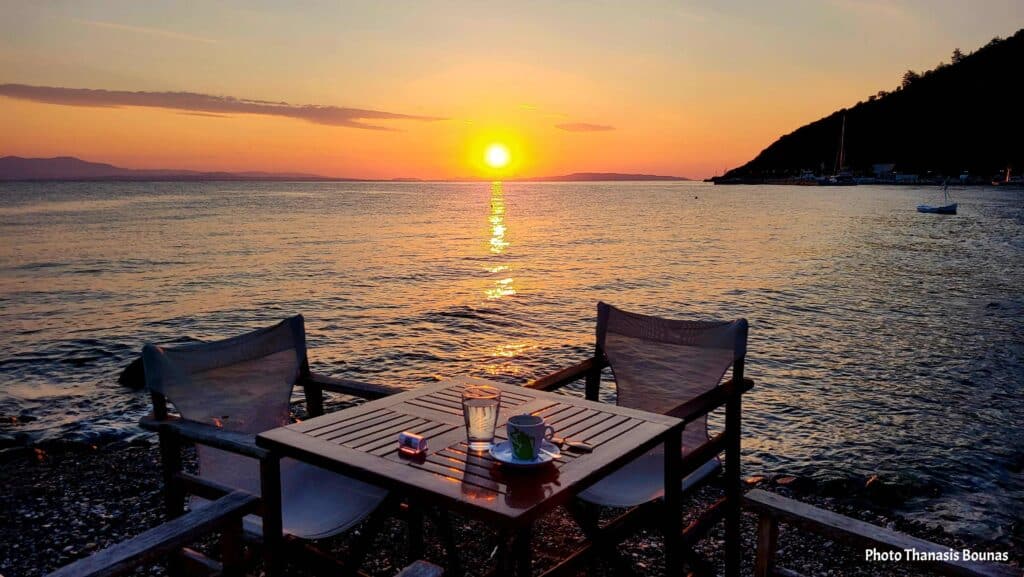 Coffee table by the sea at sunset in Tyros Arcadia with chairs and calm water view