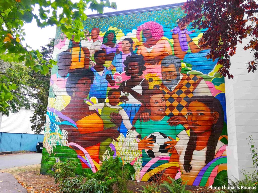 Colorful street art mural in Vancouver showing people and community themes