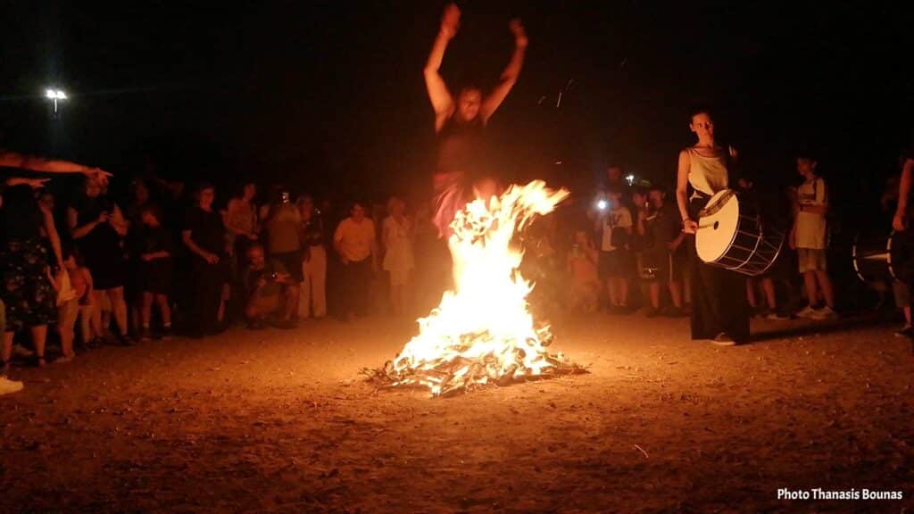 People jumping over fire during Klidonas festival in Greece with music and dancing at night