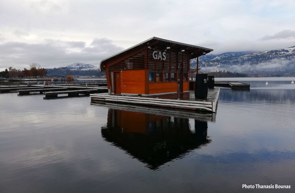 Floating dock and small building on Okanagan Lake in Kelowna with mountains in the background