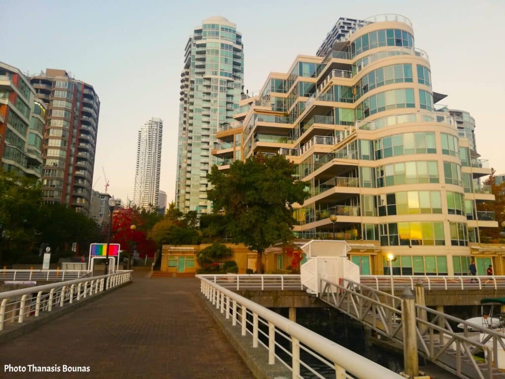 Modern waterfront residential towers and marina walkway in Vancouver British Columbia Canada
