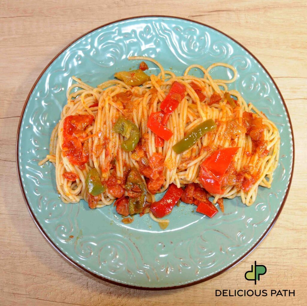 Plate of vegetarian spaghetti with red and green peppers, symbolizing balance, proportion, and psychological harmony within the philosophy of Sailing.