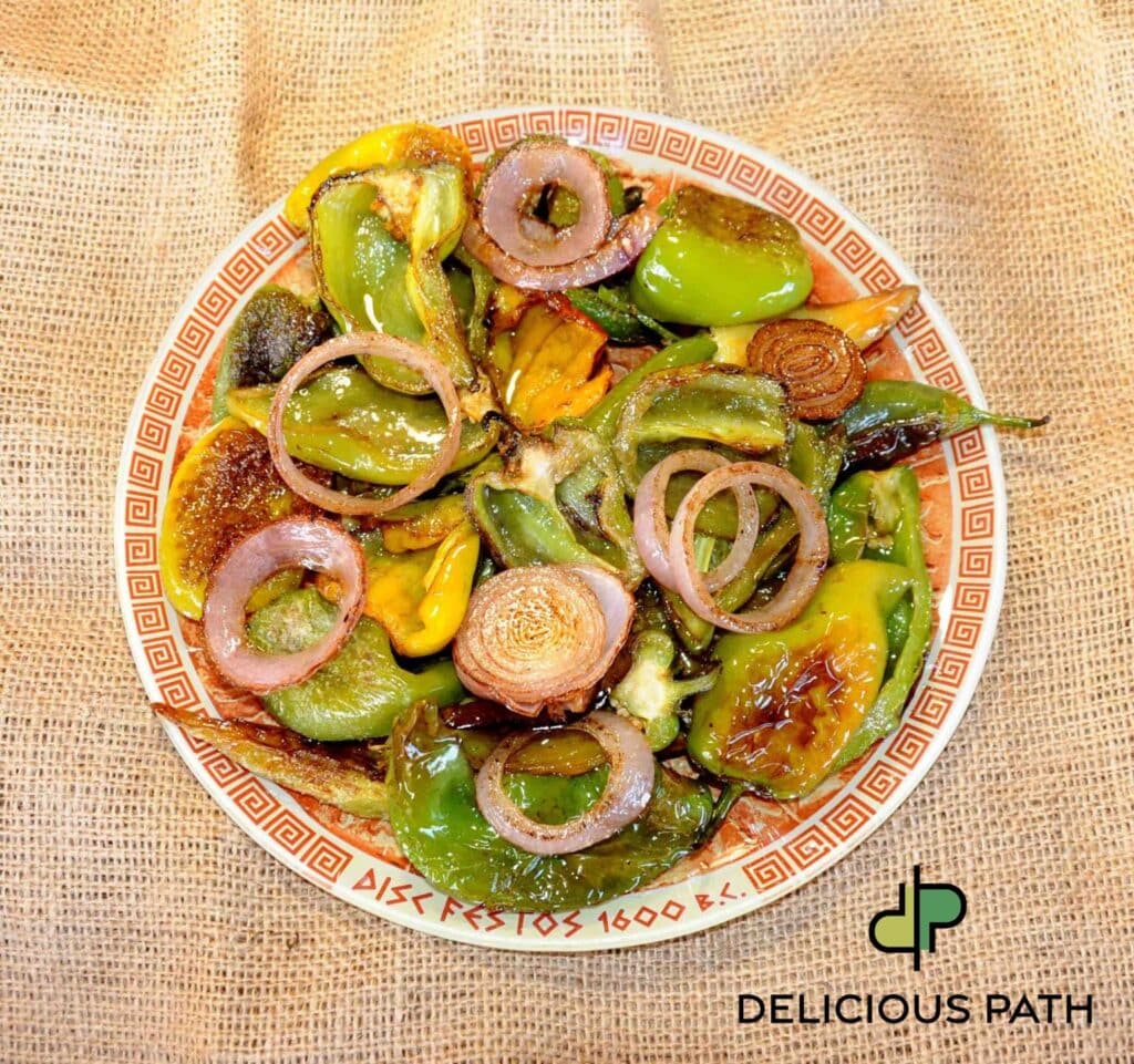 Plate of fried green peppers and onions with olive oil, symbolizing distance, balance and sailing-inspired food philosophy.