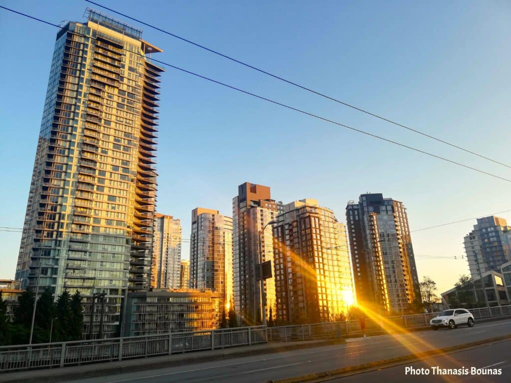 Granville Bridge Vancouver sunset with skyscrapers reflecting sunlight over False Creek