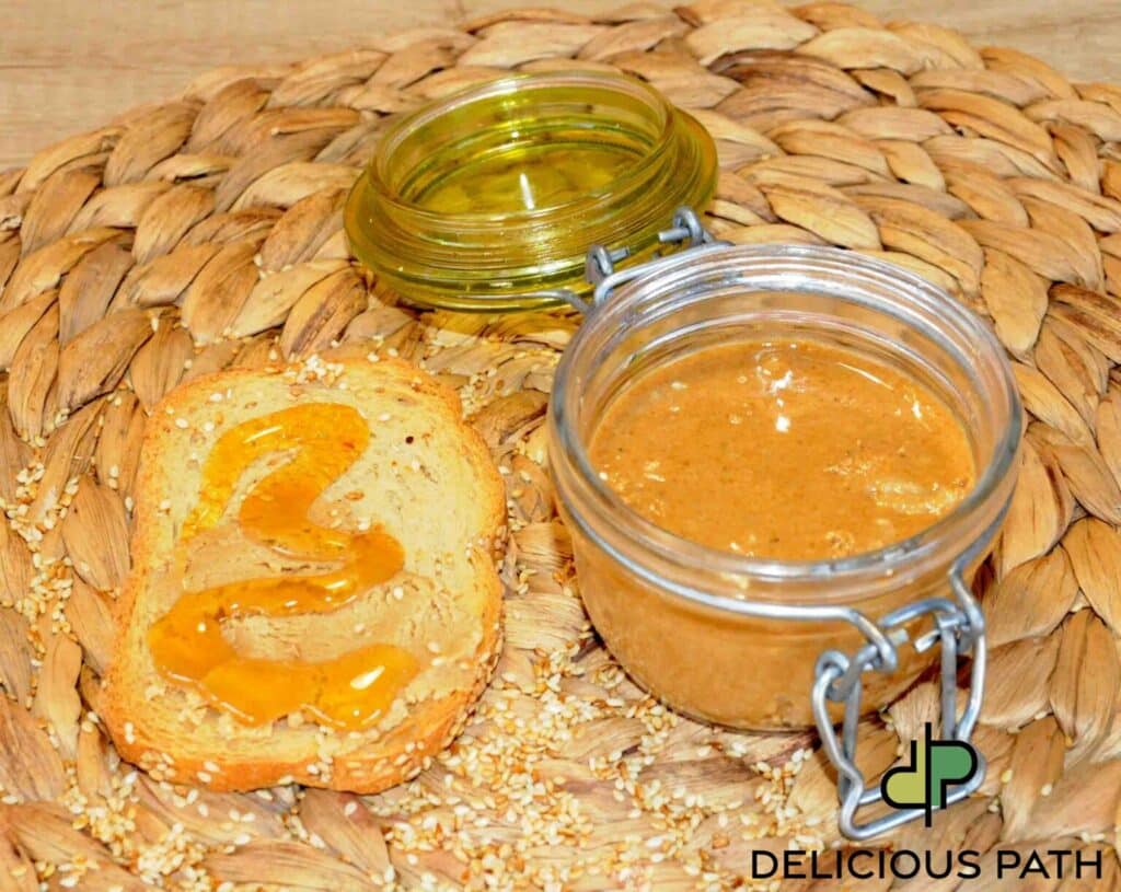 Glass jar of tahini with honey on bread symbolizing flow, simplicity and sailing-inspired food philosophy.
