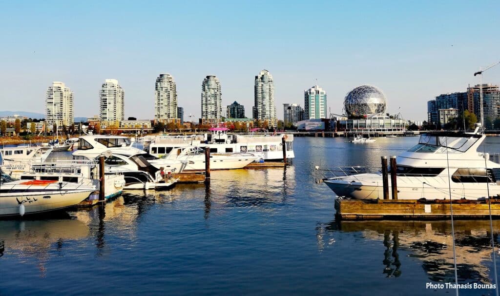 Boats at False Creek Marina with Science World and Vancouver skyline Vancouver British Columbia Canada