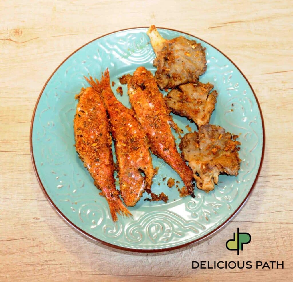 Baked red mullet with mushrooms on ceramic plate symbolizing intimacy, food, sailing, and the psychology of the journey