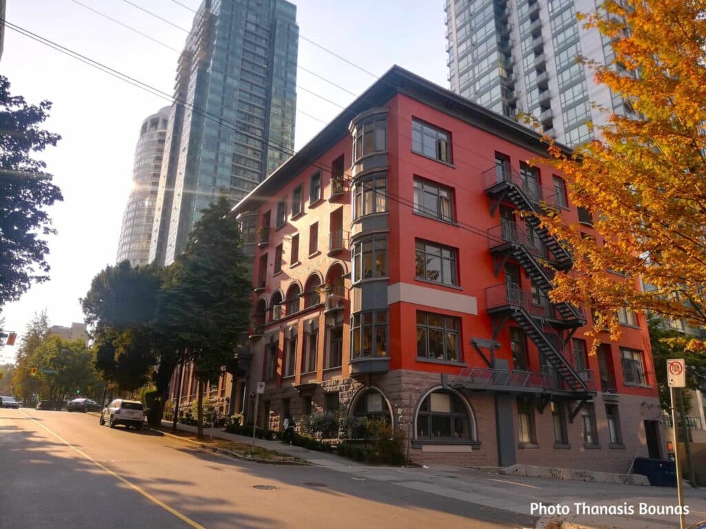 Historic red brick apartment building with fire escape in downtown Vancouver British Columbia Canada
