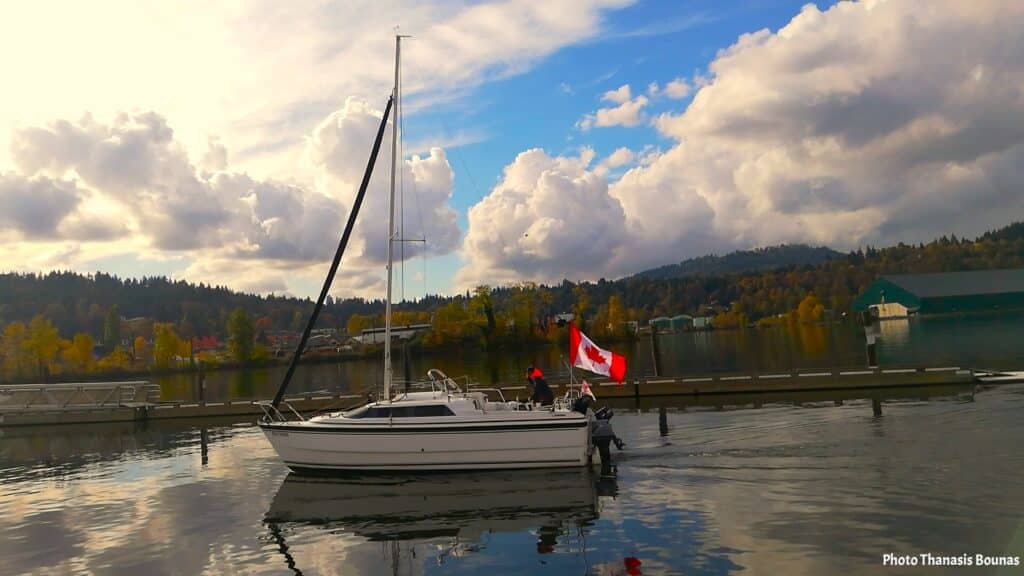 Sailboat with Canadian flag near Rocky Point Park Port Moody British Columbia Canada
