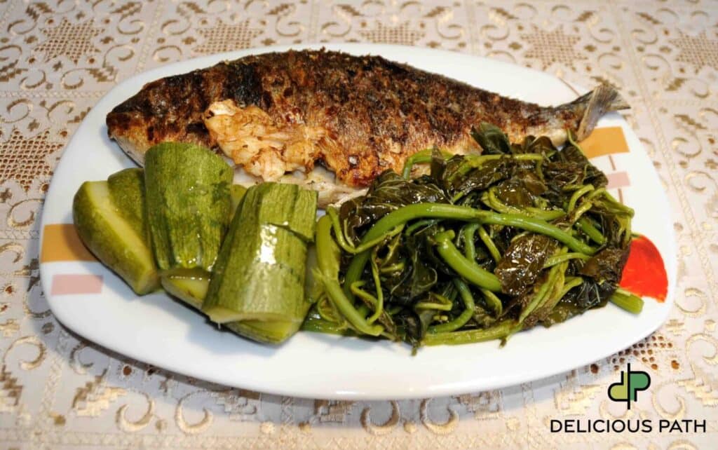 Whole sea bream with greens on a plate symbolizing presence, food philosophy, and the psychology of the inner journey