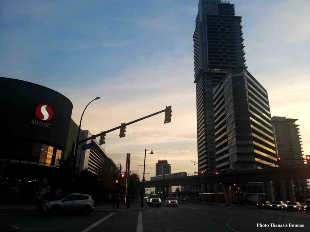 Burquitlam Vancouver skyline with SkyTrain and modern buildings at sunset