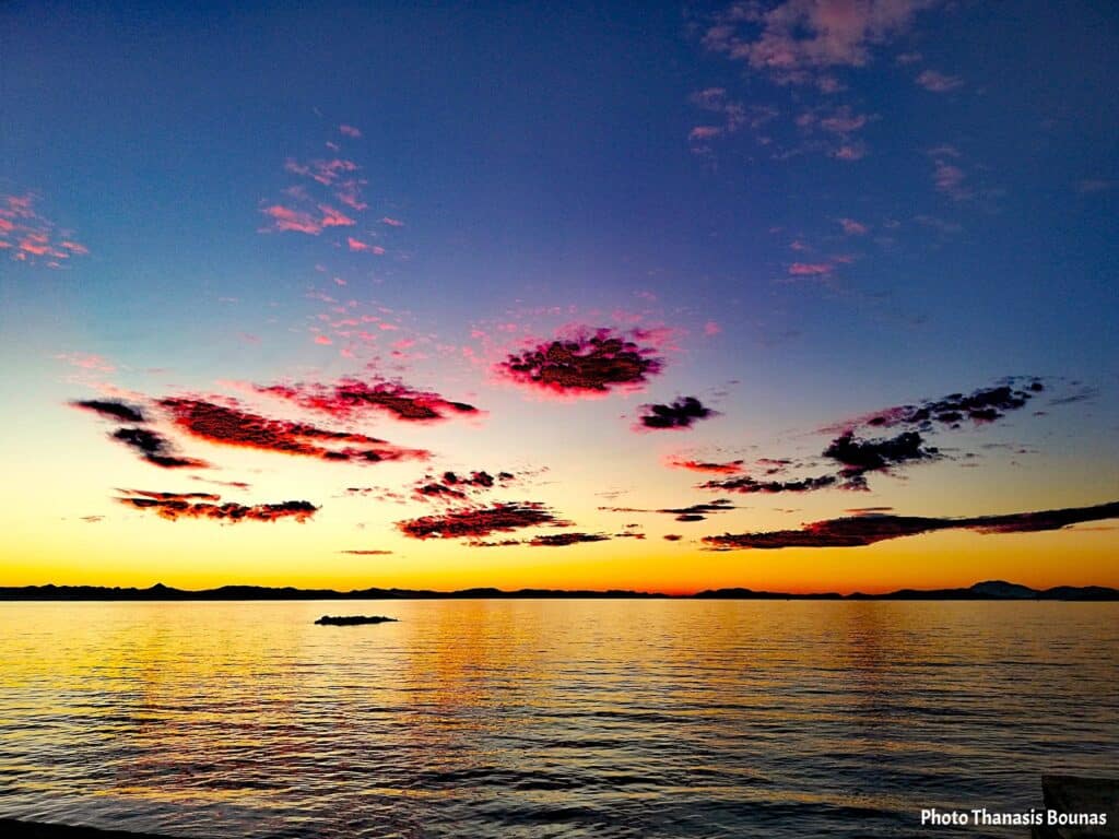 Colorful sunset over the Saronic Gulf seen from a sailboat in Greece