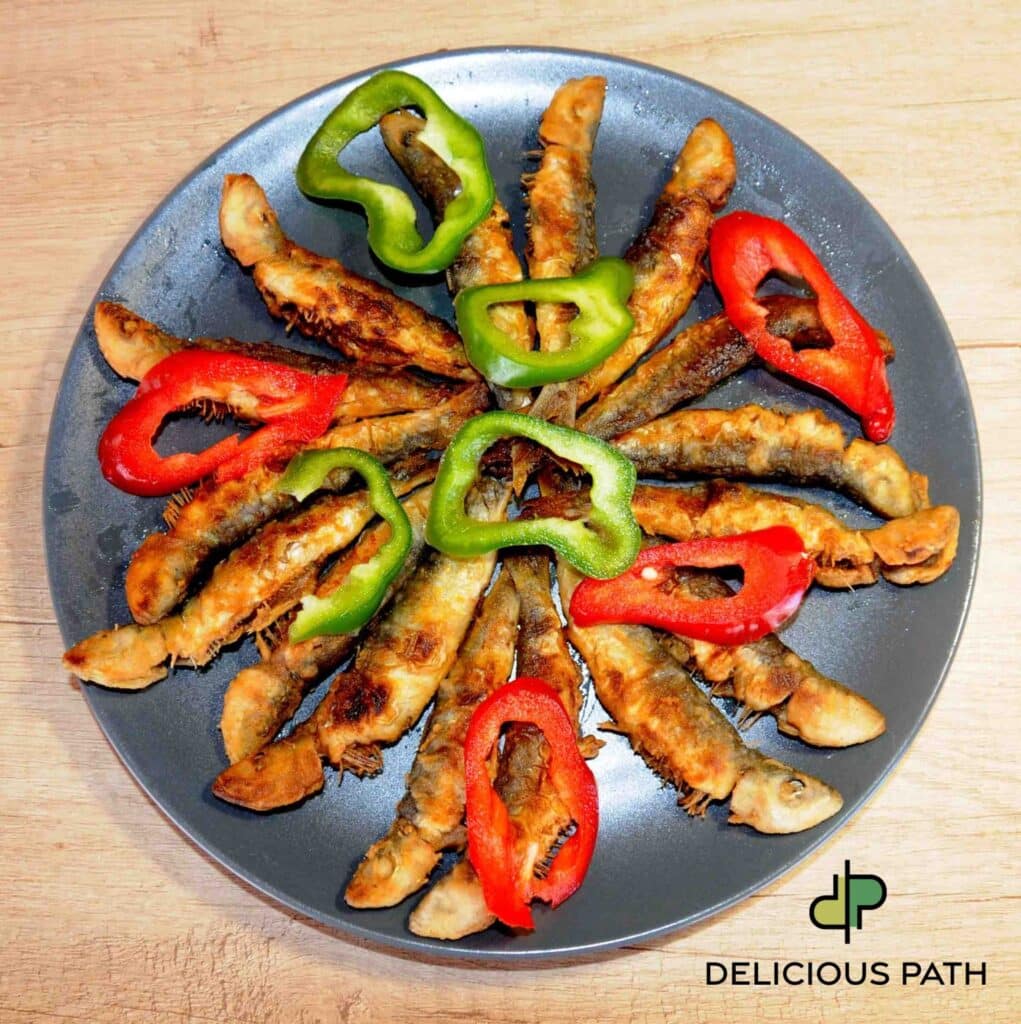 Fried sardines arranged in a circle symbolizing tenderness, sailing rhythm, and the psychology of travel