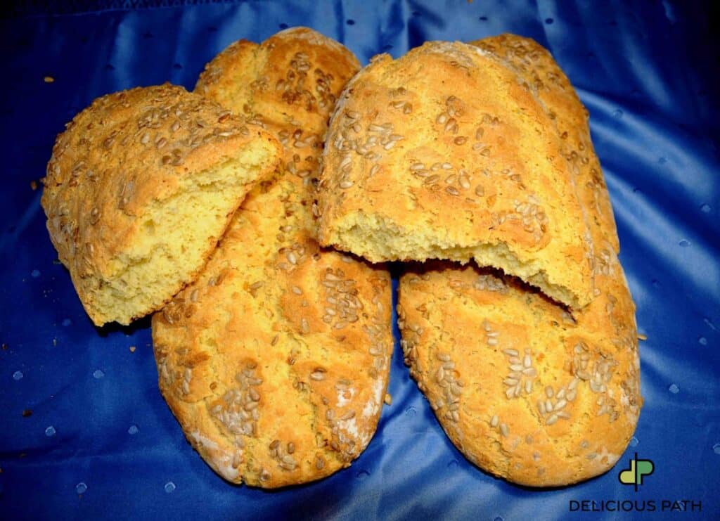 Homemade bread with sunflower seeds broken open, symbolizing threshold, nourishment and psychological transition in travel and sailing.