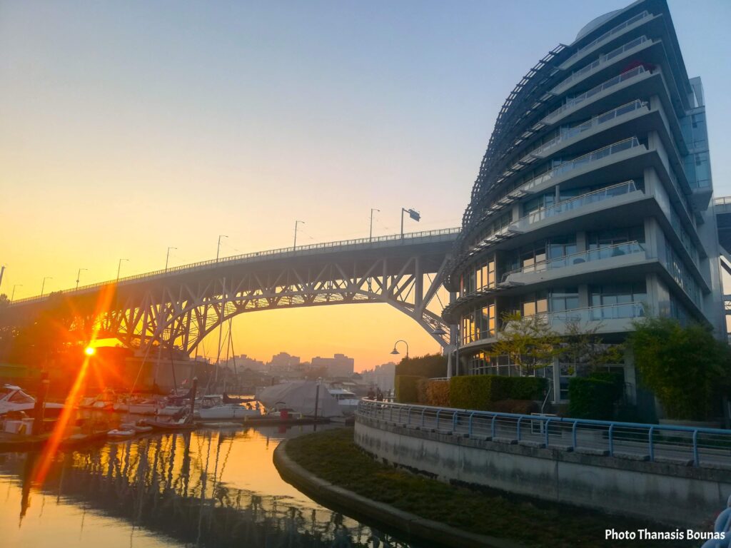 Granville Bridge Vancouver sunset with sailboats and waterfront reflections at George Wainborn Park