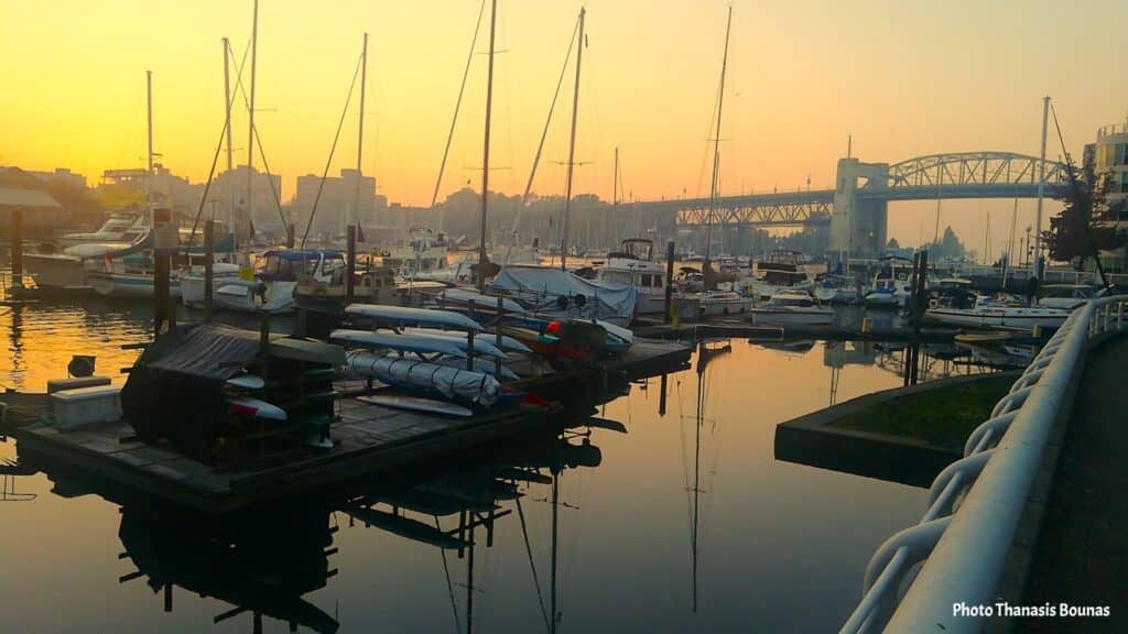 Boats and sailboats at False Creek Marina with Burrard Street Bridge in Vancouver British Columbia Canada
