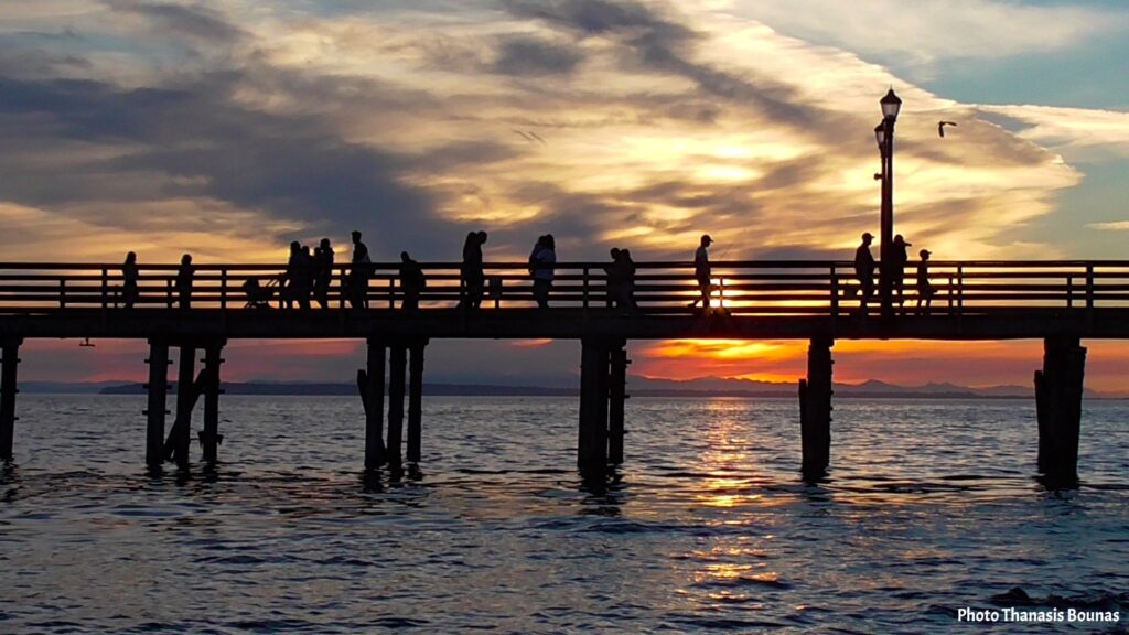 White Rock Pier sunset with silhouettes of people and ocean view toward United States border