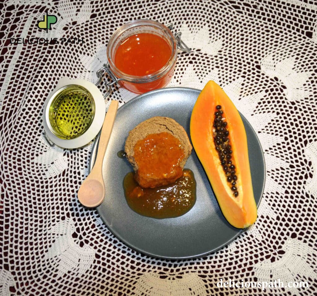 Fresh papaya with papaya jam on bread and olive oil on grey plate over lace tablecloth, symbolizing light food and sailing travel psychology