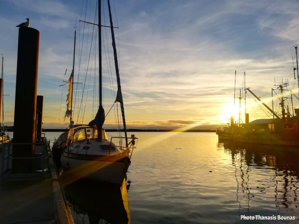 Sailboats and fishing boats at sunset in Steveston harbor Richmond British Columbia Canada
