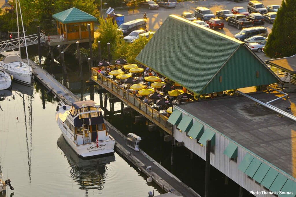 Marina with boats and waterfront restaurant in North Vancouver British Columbia Canada