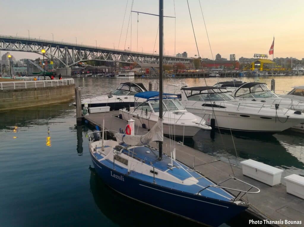 A sailboat resting in the marina across from Granville Island with Granville Bridge in the background, Vancouver – Photo Thanasis Bounas