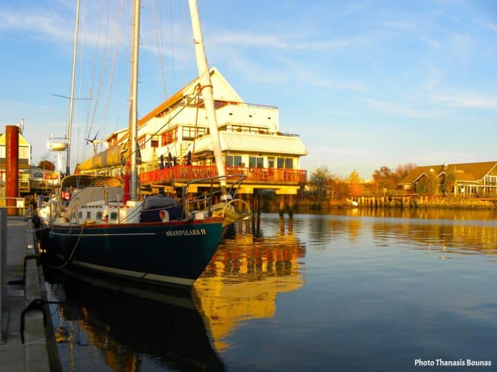 A sailboat resting quietly in the marina, waiting for the next sailing journey to begin - Photo Thanasis Bounas