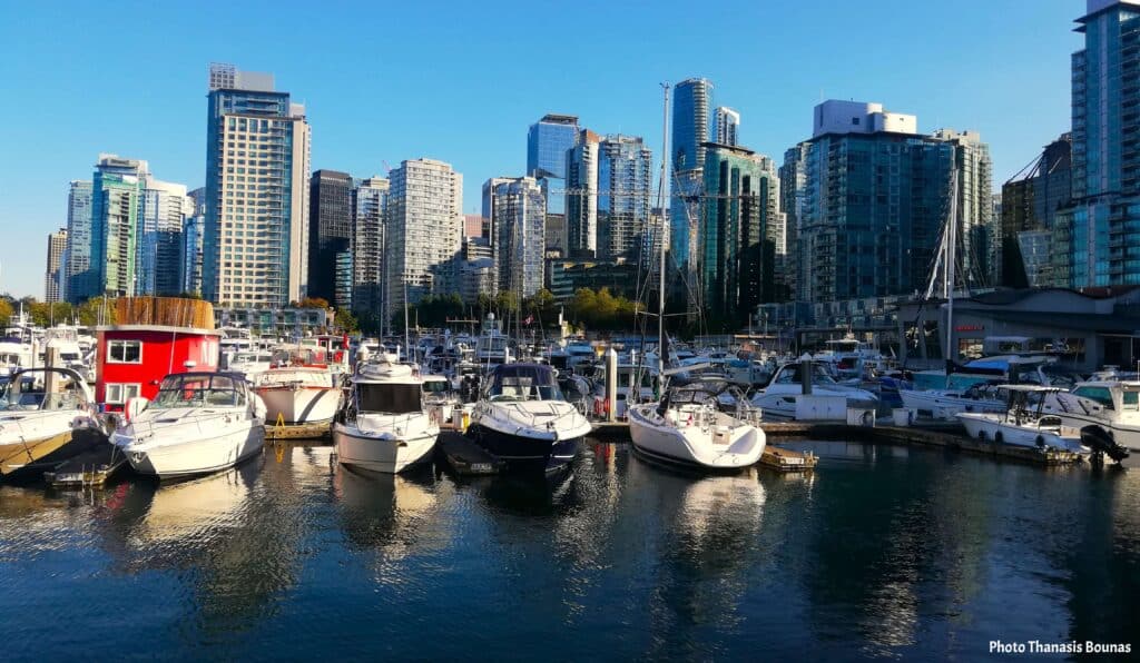 Boats and marina at Coal Harbour near Cardero Park with Vancouver skyline in the background