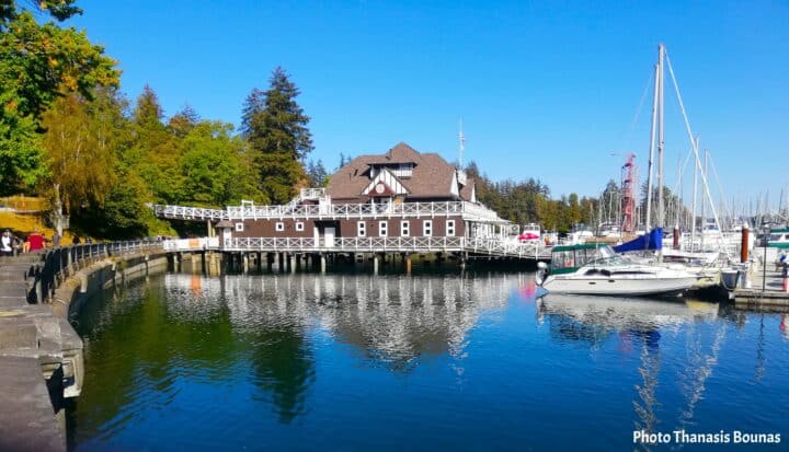 The Vancouver Rowing Club reflected in the calm waters of Coal Harbour, surrounded by sailboats and marina life – Photo Thanasis Bounas