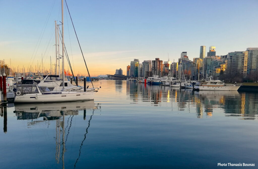 Sailing boats and marina reflection at Devonian Harbour Park with Vancouver skyline