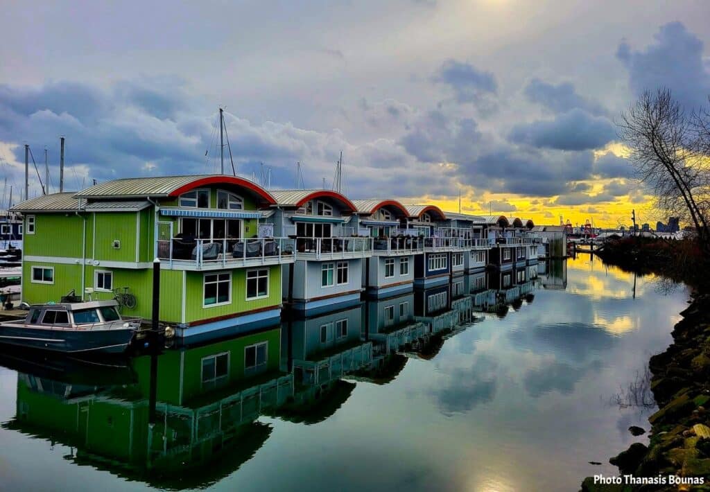 Floating homes at Mosquito Creek Marina reflecting on calm water at sunset, symbolizing waterfront transformation in North Vancouver