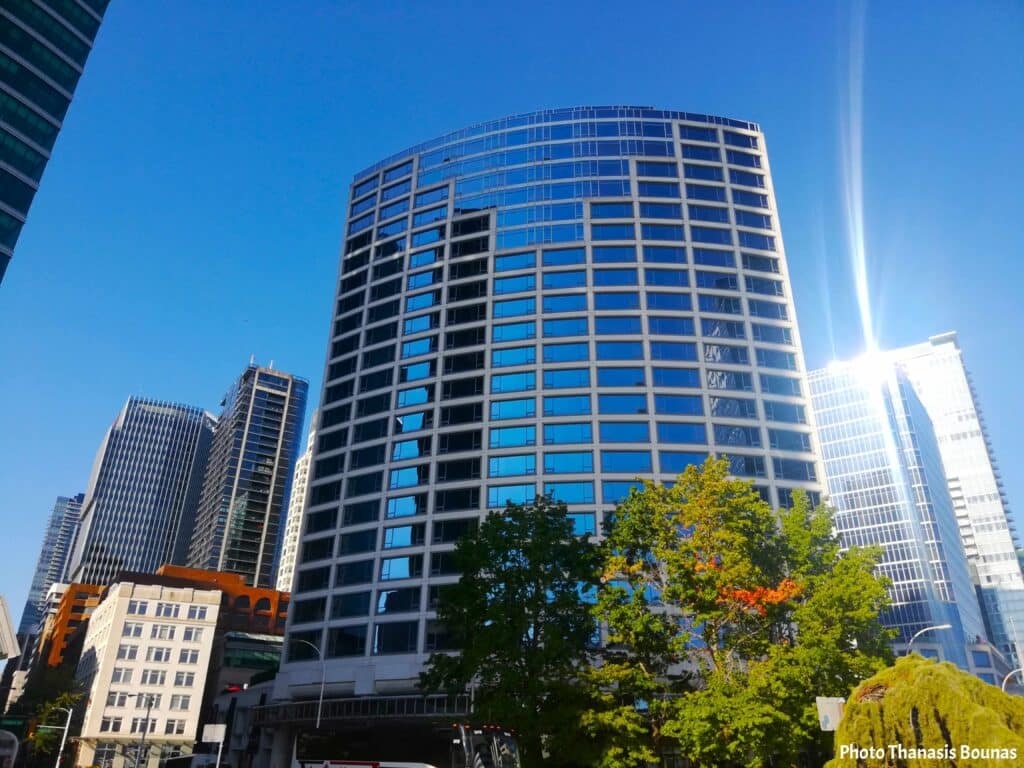 Glass skyscrapers in downtown Vancouver under a clear blue sky