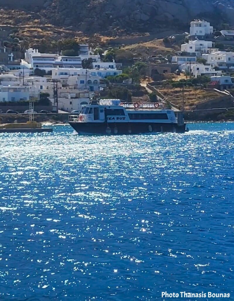 Boat exploring the coastline and beaches of Mykonos, Greece