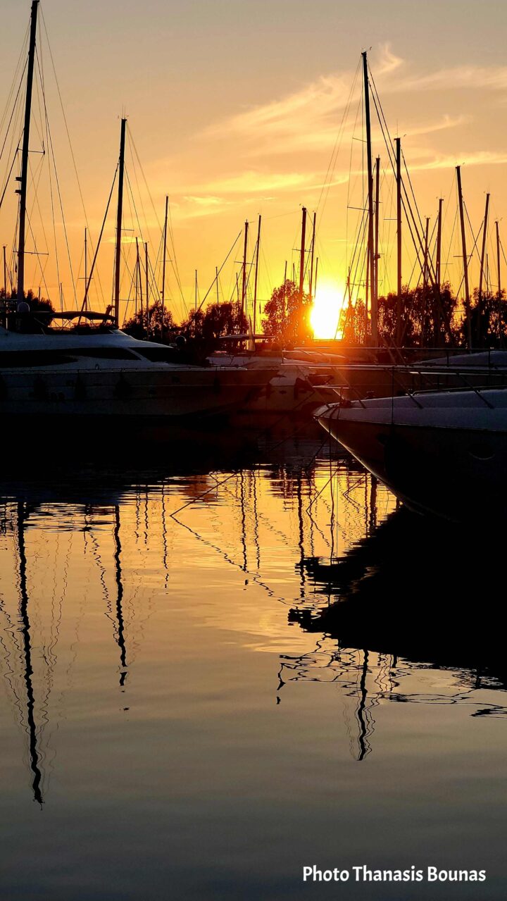 Sailboats returning to the Athens Riviera in the golden light of sunset. Photo by Thanasis Bounas.