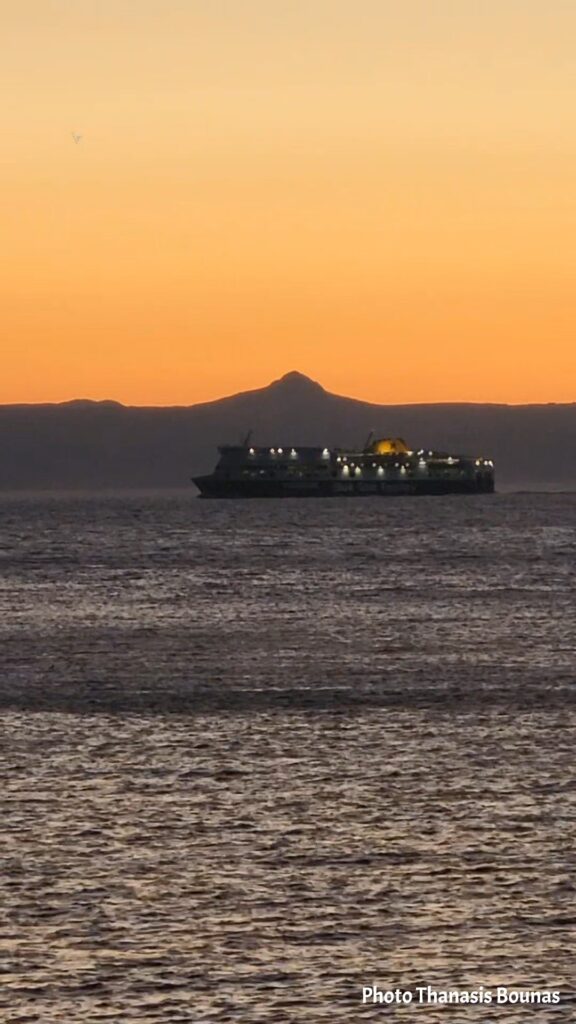 Ship passing Karpathos at dusk in the Dodecanese, Greece