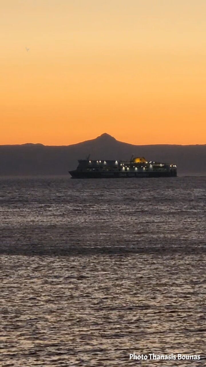 A passing ship becomes a silhouette as evening falls over Karpathos and the Aegean Sea. Photo by Thanasis Bounas