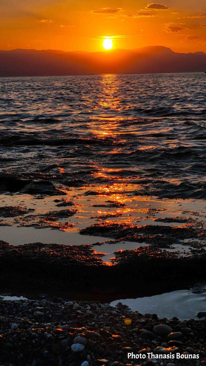 Golden evening light across the Corinthian Gulf in Loutraki, Greece. Photo by Thanasis Bounas.