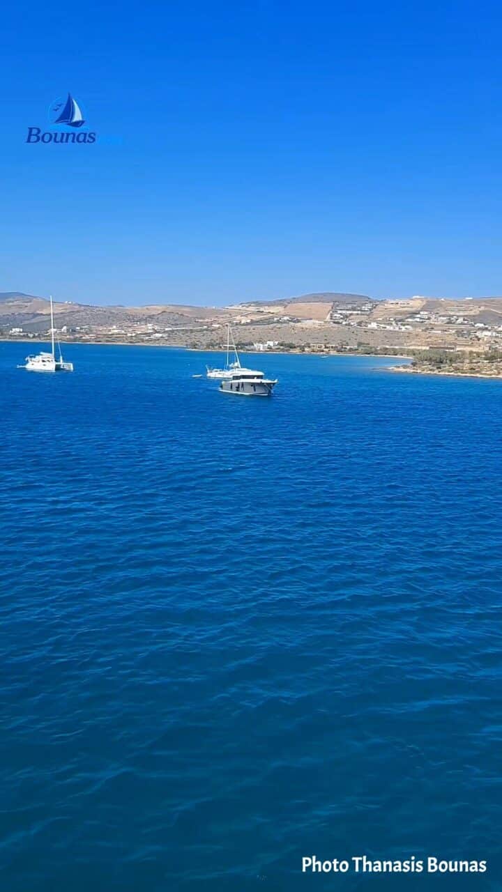 Sailboats resting on the deep blue Aegean waters around Antiparos in the Cyclades, Greece. Photo by Thanasis Bounas.